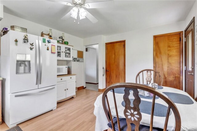 10110 Rinaman Rd, Mccandless, PA 15090 - kitchen with white appliances, ceiling fan, light wood-type flooring, glass insert cabinets, and white cabinetry