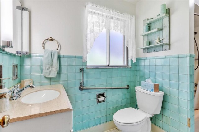 10110 Rinaman Rd, Mccandless, PA 15090 - full bathroom featuring tile walls, vanity, a wainscoted wall, and a shower