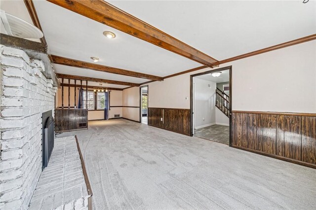 2096 Ramsey Rd, Monroeville, PA 15146 - unfurnished living room featuring light carpet, a fireplace, wooden walls, a wainscoted wall, and beamed ceiling