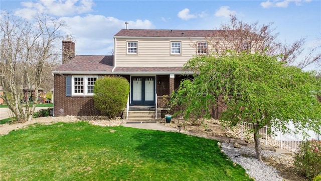 2096 Ramsey Rd, Monroeville, PA 15146 - view of front facade with brick siding, french doors, a front lawn, and a chimney