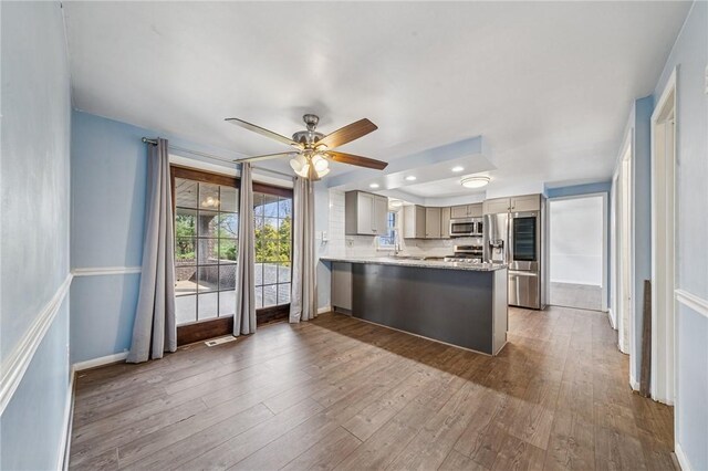 2096 Ramsey Rd, Monroeville, PA 15146 - kitchen featuring gray cabinetry, a peninsula, wood finished floors, and appliances with stainless steel finishes