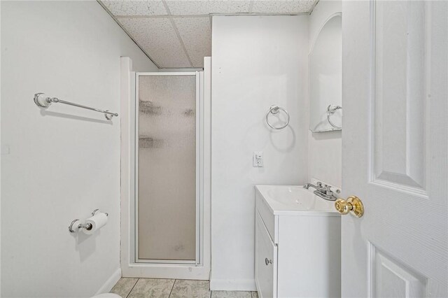 2096 Ramsey Rd, Monroeville, PA 15146 - bathroom with vanity, baseboards, a stall shower, tile patterned flooring, and a drop ceiling