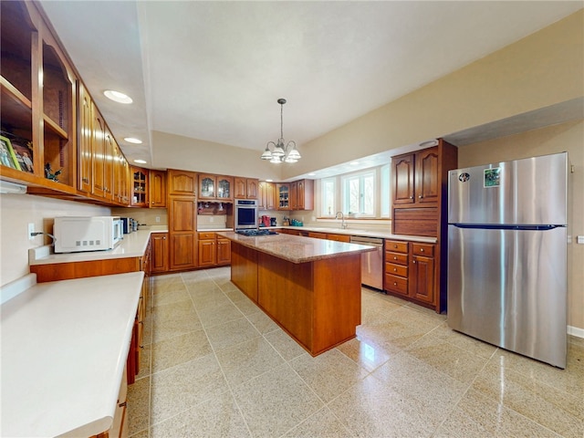 221 Pitgas Rd, Clarksville, PA 15322 - kitchen with a center island, a notable chandelier, brown cabinetry, recessed lighting, and stainless steel appliances