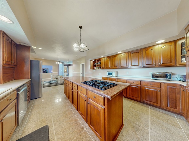 221 Pitgas Rd, Clarksville, PA 15322 - kitchen featuring decorative light fixtures, appliances with stainless steel finishes, a chandelier, brown cabinetry, and a kitchen island