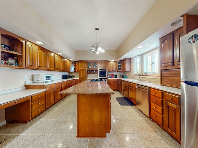 221 Pitgas Rd, Clarksville, PA 15322 - kitchen featuring a center island, a sink, brown cabinetry, and appliances with stainless steel finishes