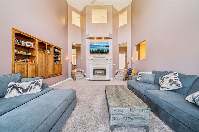 221 Pitgas Rd, Clarksville, PA 15322 - living area with baseboards, a fireplace, a high ceiling, carpet floors, and stairs