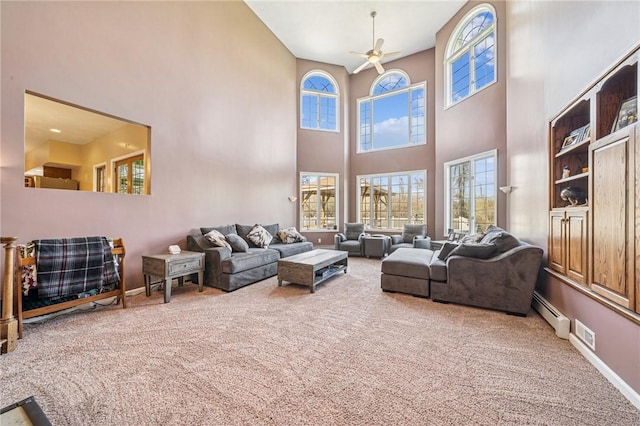 221 Pitgas Rd, Clarksville, PA 15322 - carpeted living area with baseboards, a ceiling fan, a towering ceiling, and baseboard heating
