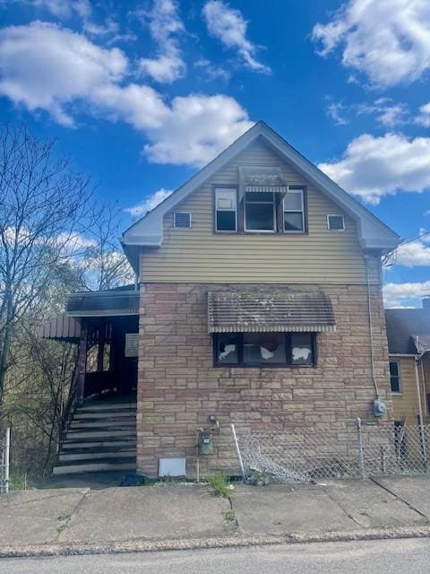 504 Chestnut St, Monessen, PA 15062 - view of side of home with fence and stone siding
