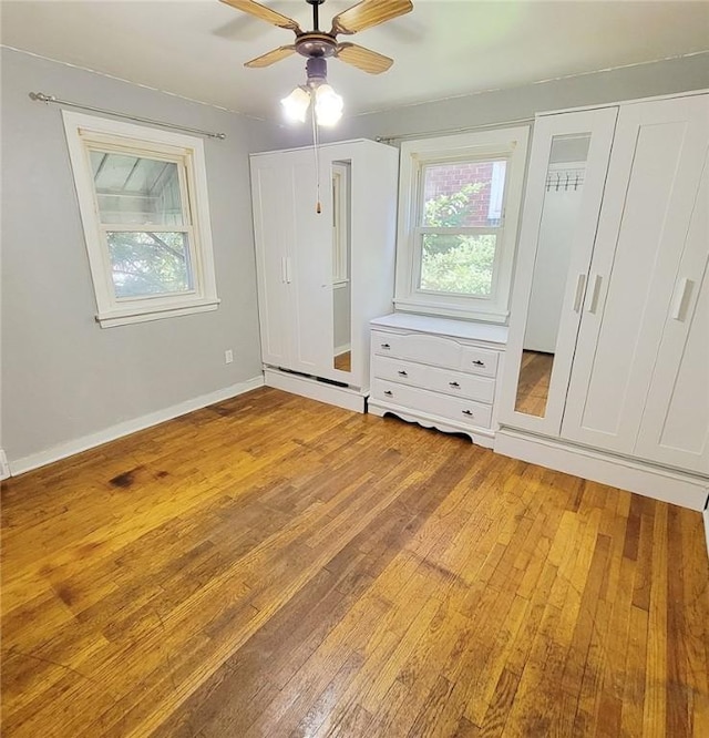 unfurnished bedroom featuring light wood-style floors, baseboards, and a ceiling fan