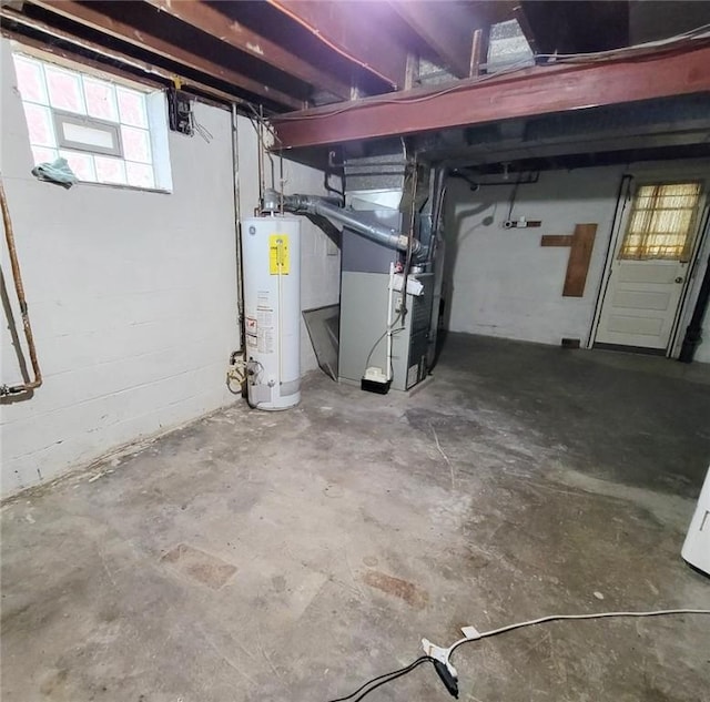 below grade area featuring gas water heater and heating unit