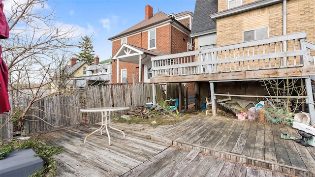 wooden terrace featuring fence