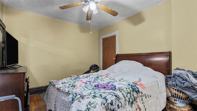 bedroom with a ceiling fan and wood finished floors