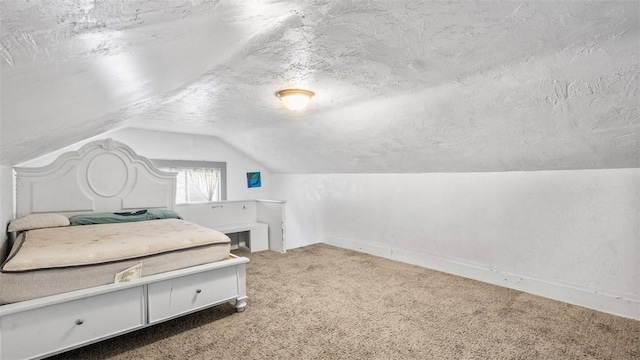 bedroom featuring carpet floors, baseboards, a textured ceiling, and lofted ceiling