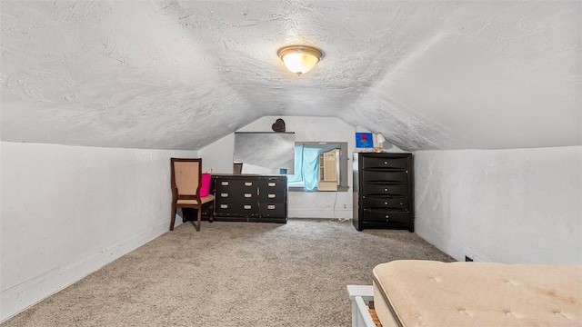 bedroom with a textured ceiling, baseboards, carpet, and vaulted ceiling