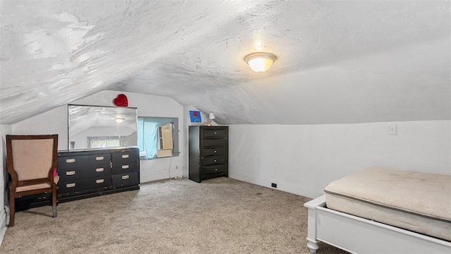 carpeted bedroom with baseboards, vaulted ceiling, and a textured ceiling