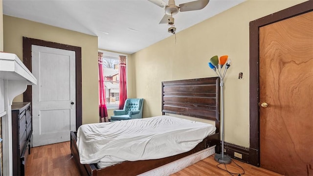 bedroom with a ceiling fan and wood finished floors