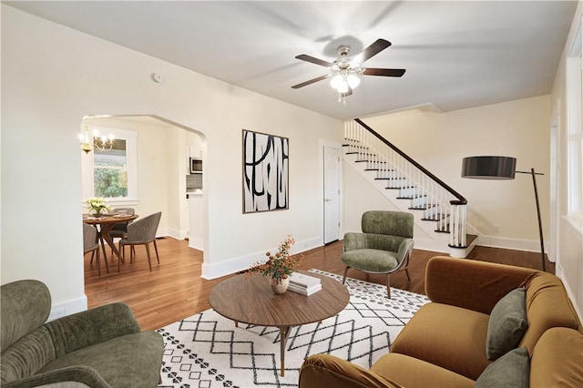 3032 Churchview Ave, Brentwood, PA 15227 - living area with wood finished floors, ceiling fan with notable chandelier, baseboards, arched walkways, and stairs