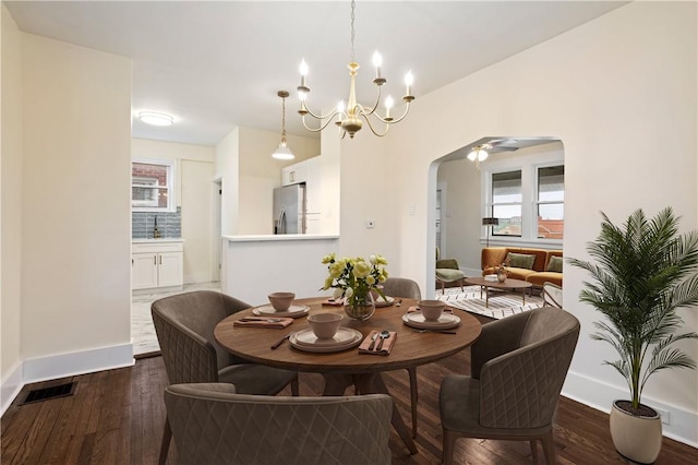 3032 Churchview Ave, Brentwood, PA 15227 - dining room with arched walkways, dark wood-style flooring, baseboards, and a chandelier