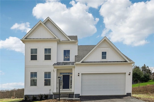 modern farmhouse with a shingled roof, an attached garage, aphalt driveway, a standing seam roof, and metal roof