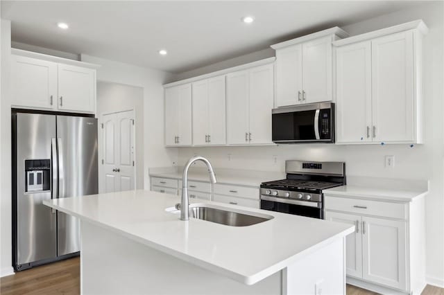 kitchen with white cabinetry, appliances with stainless steel finishes, and a sink