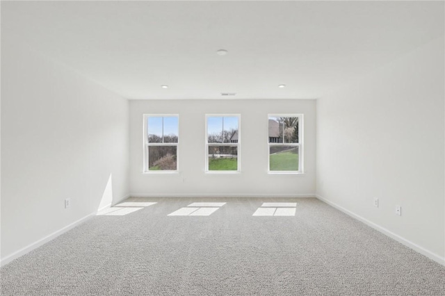 spare room with baseboards and carpet