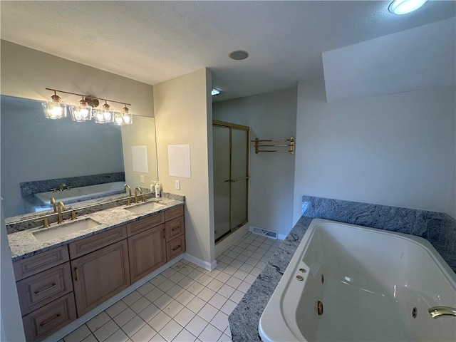 full bath featuring tile patterned floors, a jetted tub, and a sink
