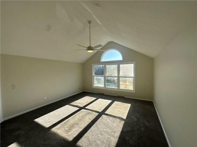 bonus room with a ceiling fan, visible vents, dark colored carpet, lofted ceiling, and baseboards
