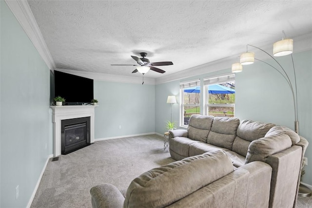 carpeted living area featuring a fireplace with flush hearth, crown molding, ceiling fan, and baseboards
