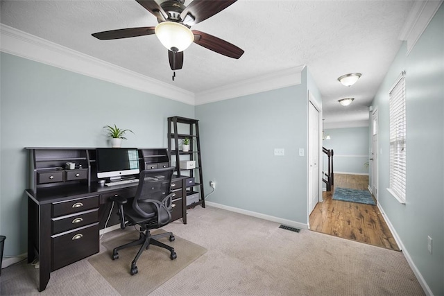 carpeted home office with visible vents, baseboards, and crown molding