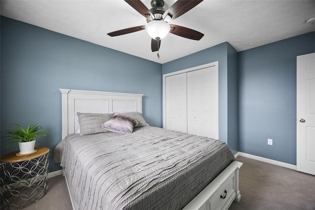 bedroom with a closet, baseboards, dark colored carpet, and ceiling fan