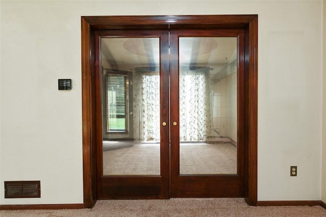 hall featuring french doors, carpet flooring, baseboards, and visible vents