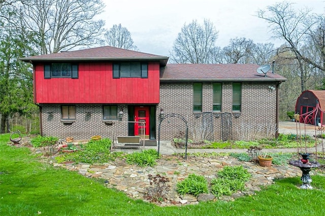 split level home featuring brick siding and an outdoor structure
