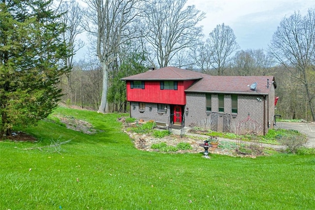 view of front of property with a front yard and brick siding