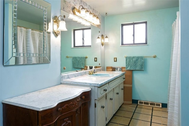 full bathroom featuring tile patterned floors, vanity, baseboards, and visible vents