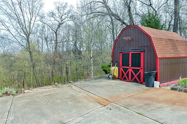 view of shed with a wooded view