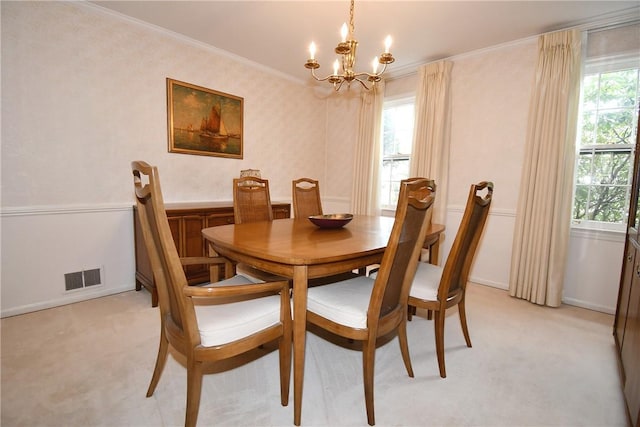 dining area with light colored carpet, ornamental molding, visible vents, baseboards, and a notable chandelier
