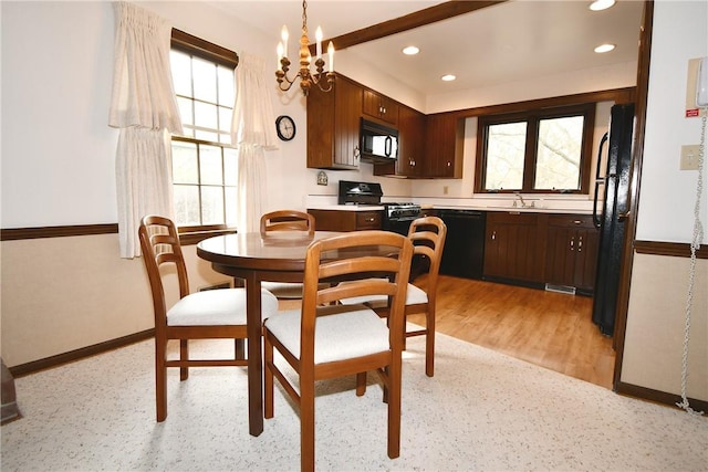 dining area featuring light wood finished floors, a notable chandelier, baseboards, and recessed lighting