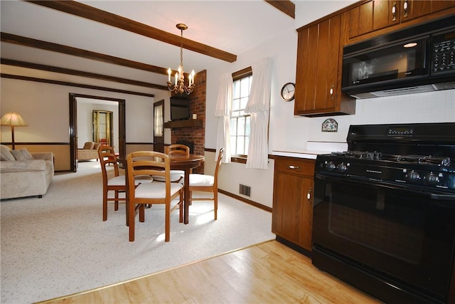 kitchen featuring a chandelier, visible vents, brown cabinets, beamed ceiling, and black appliances