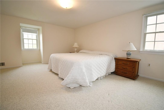bedroom with light carpet, baseboards, and visible vents