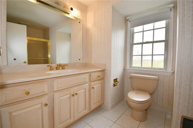 full bath featuring a shower with door, vanity, wallpapered walls, tile patterned floors, and toilet