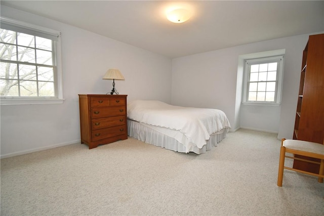 carpeted bedroom featuring baseboards