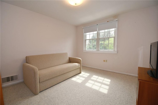 sitting room featuring carpet flooring, visible vents, and baseboards