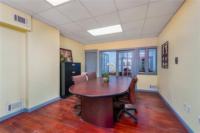 office with dark wood-style flooring, visible vents, and a drop ceiling