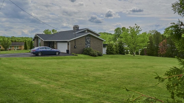 107 Spring Ln, South Union Twp, PA 15401 - view of side of home featuring driveway, an attached garage, a lawn, and a chimney