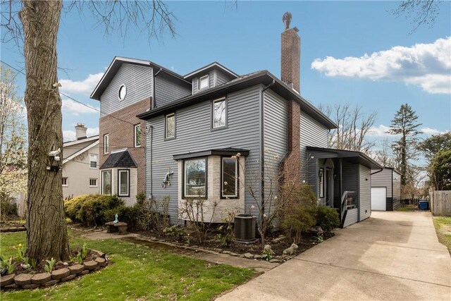 exterior space featuring central AC unit and a chimney