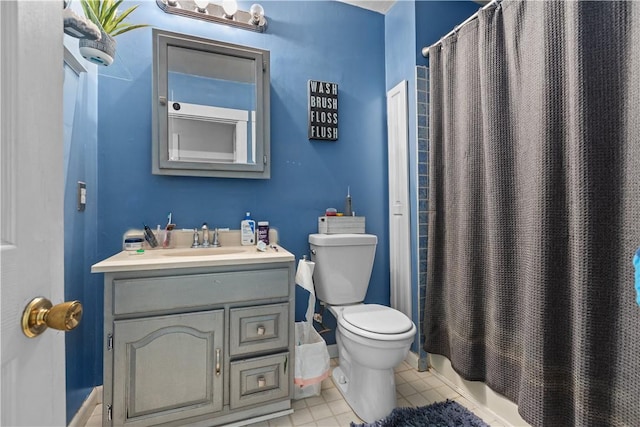 bathroom featuring toilet, curtained shower, vanity, and tile patterned flooring