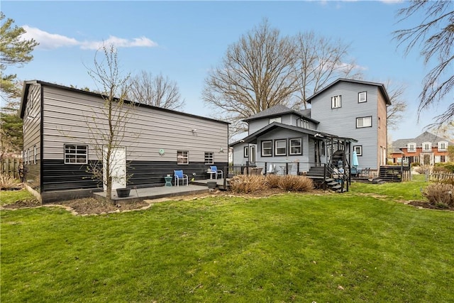 back of property with a yard and a deck
