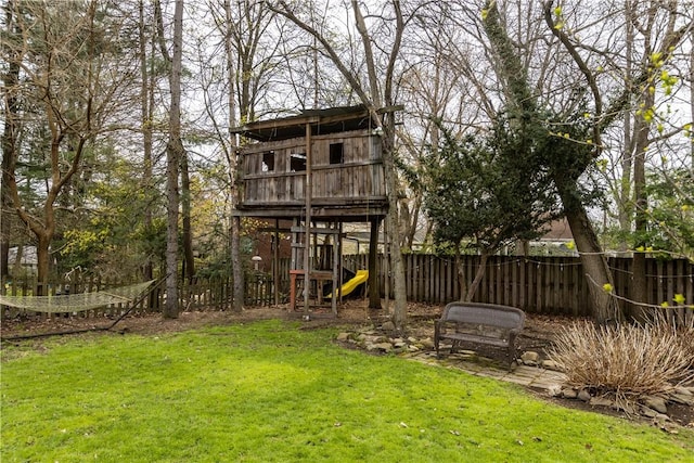 exterior space featuring a playground and fence