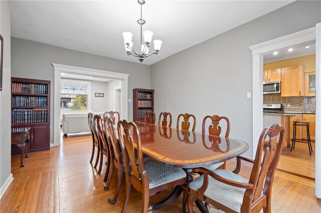 6429 Bartlett St, Squirrel Hill, PA 15217 - dining space featuring light wood-type flooring and a notable chandelier