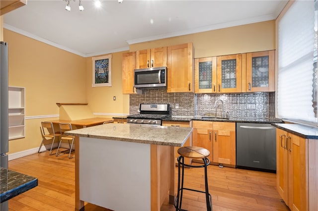 6429 Bartlett St, Squirrel Hill, PA 15217 - kitchen with tasteful backsplash, a center island, stainless steel appliances, light wood finished floors, and a sink